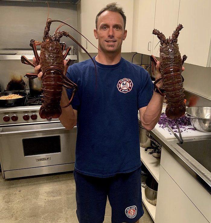 Surfer and Firefighter Mike Golder with two lobsters