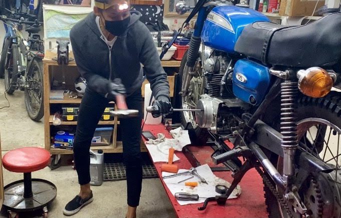 Brittney Barrios of Santa Cruz working on a motorcycle
