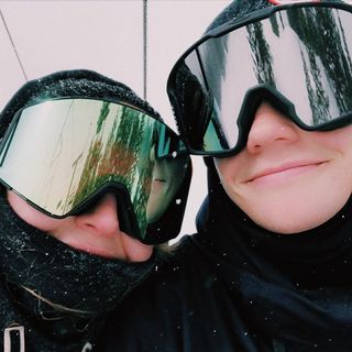 Skateboarder Nikki Rodger and his girlfriend, Grace, riding a chair lift at the ski resort